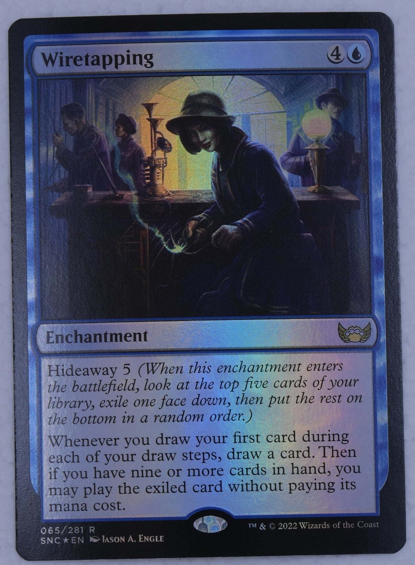 Wiretapping foil enchantment card from Streets of New Capenna Magic the Gathering