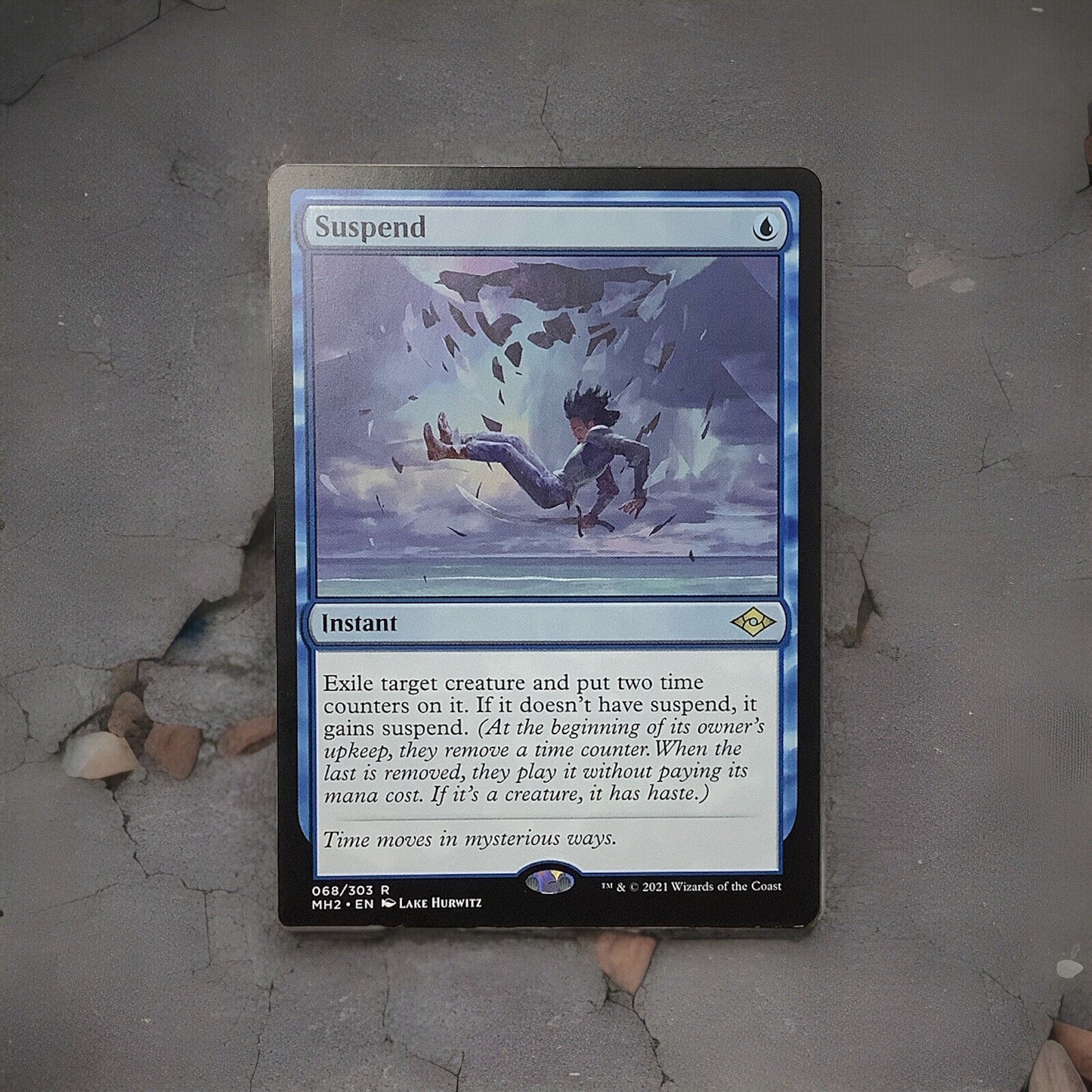 Suspend rare instant card from Modern Horizons 2 Magic the Gathering set displayed on a gray surface