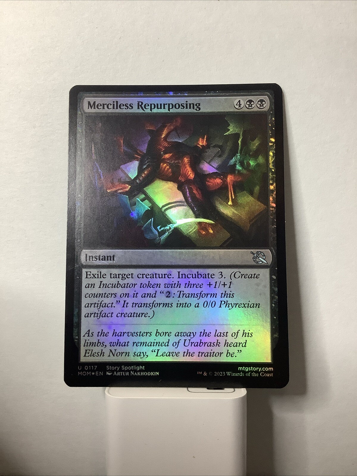 Merciless Repurposing Foil from March of the Machine, card #117.