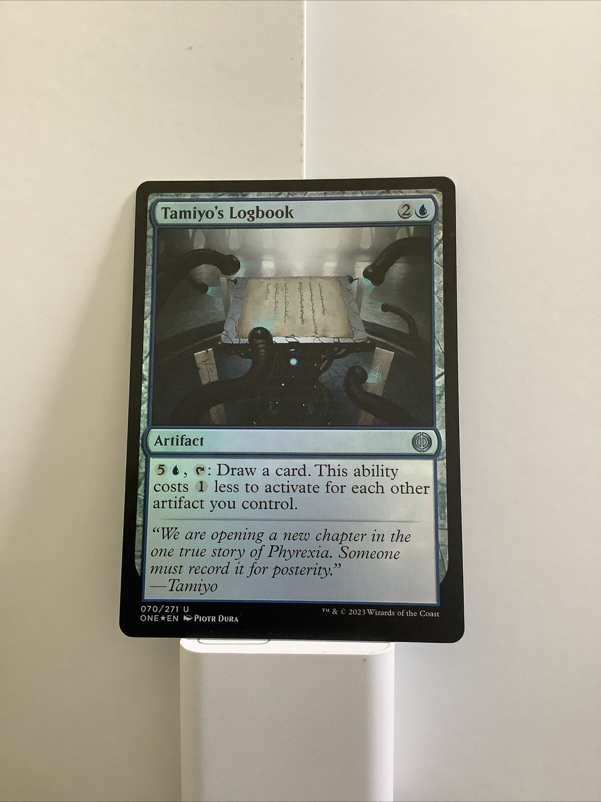 Tamiyo's Logbook foil finish MTG card ONE 070 from DM Vault Co