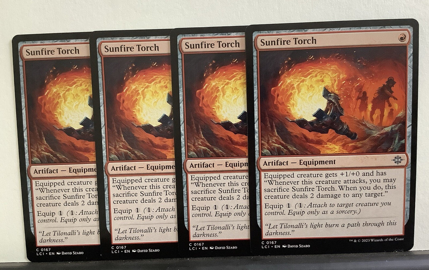Four Sunfire Torch artifact equipment cards from LCI, card number 167, common