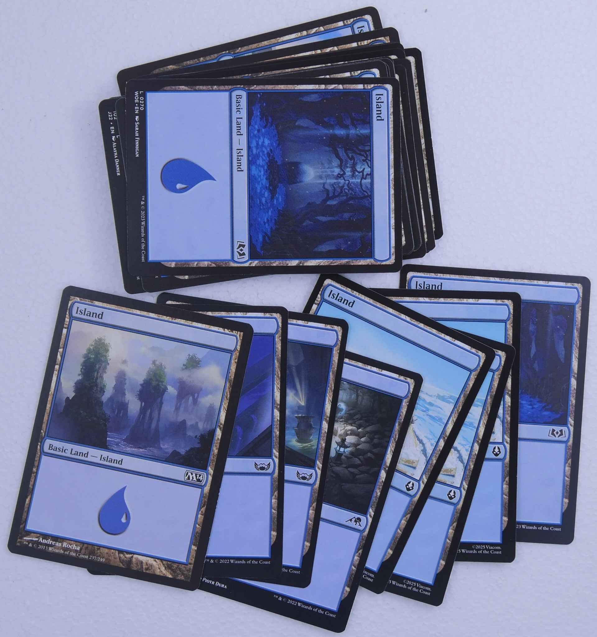 30 Magic the Gathering Island basic land cards with mixed artwork and printings
