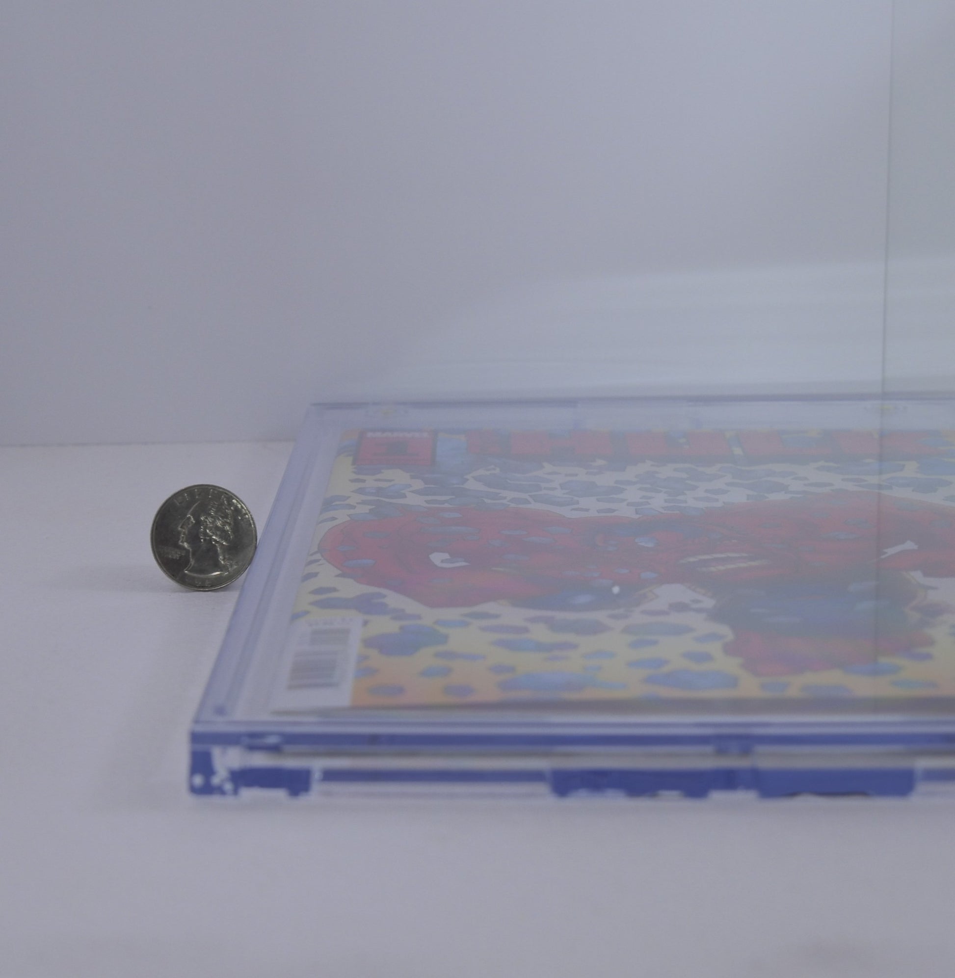 Side profile showing thickness of BCW magnetic comic book holder next to a coin