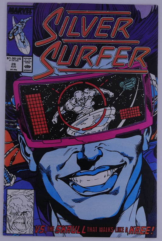 Silver Surfer #26 Marvel cover showing a large face wearing visor goggles with Silver Surfer seen in a target reticle, text reading vs the Skrull that walks like a Kree.
