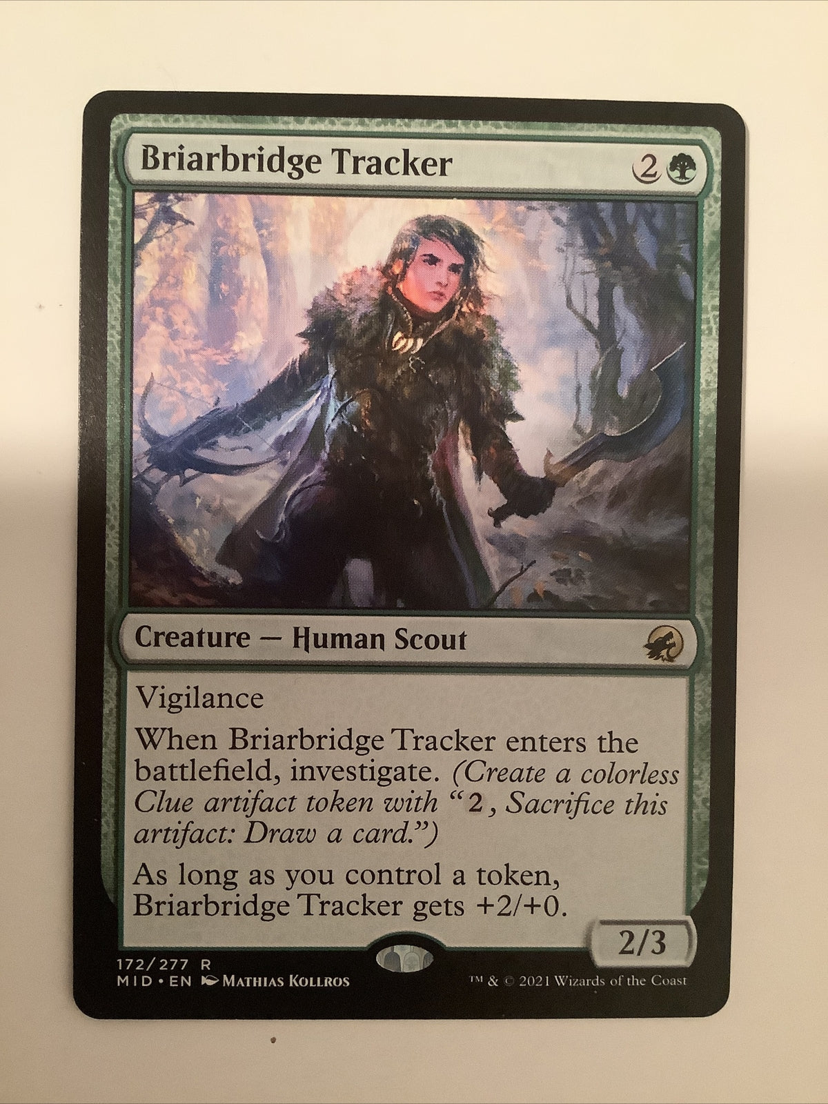 Briarbridge Tracker MID 172 Magic the Gathering Human Scout creature card with investigate ability from Innistrad Midnight Hunt.