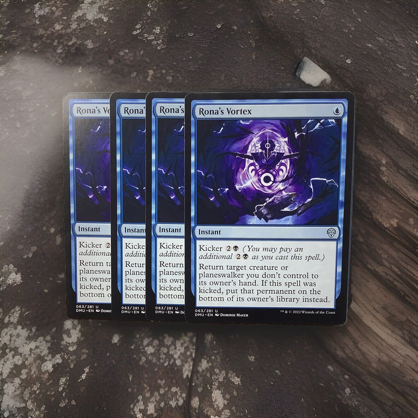 Rona’s Vortex uncommon instant card lot of four from Dominaria United Magic the Gathering set displayed on a stone surface