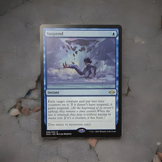 Suspend rare instant card from Modern Horizons 2 Magic the Gathering set displayed on a gray surface