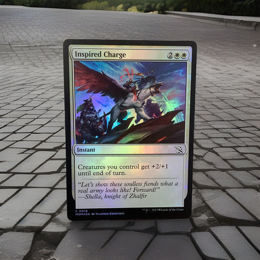 March of the Machine Inspired Charge #19 foil instant featuring team-wide combat buffs, token synergies, and aggressive finisher potential.