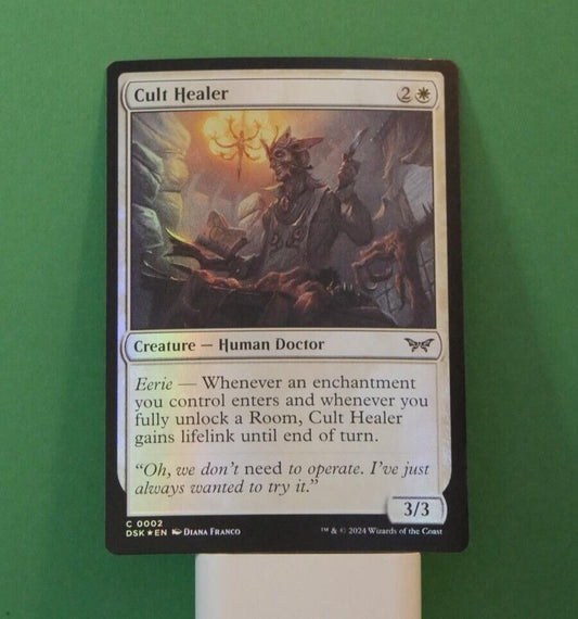 Duskmourn Cult Healer #2 foil featuring Eerie triggers, enchantment synergies, and repeatable lifelink value.