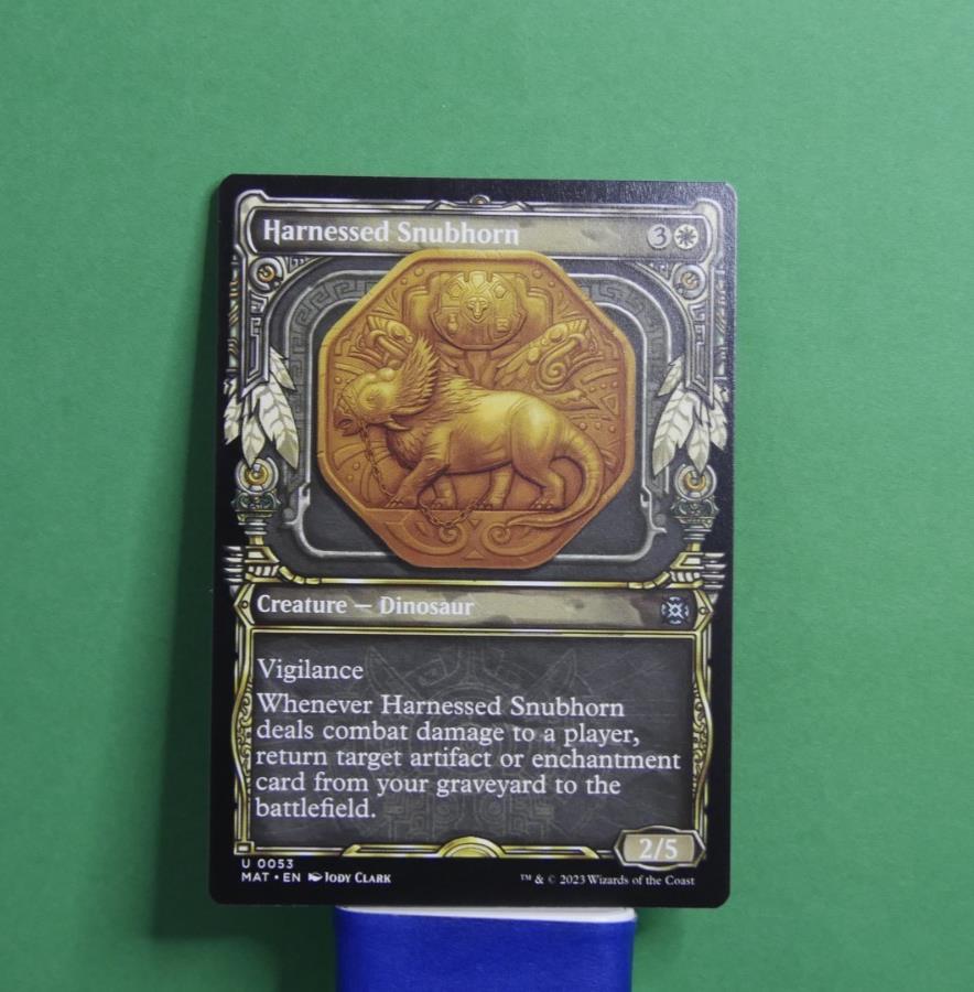 Harnessed Snubhorn Showcase MTG card from March of the Machine Aftermath MAT 53 by DM Vault Co