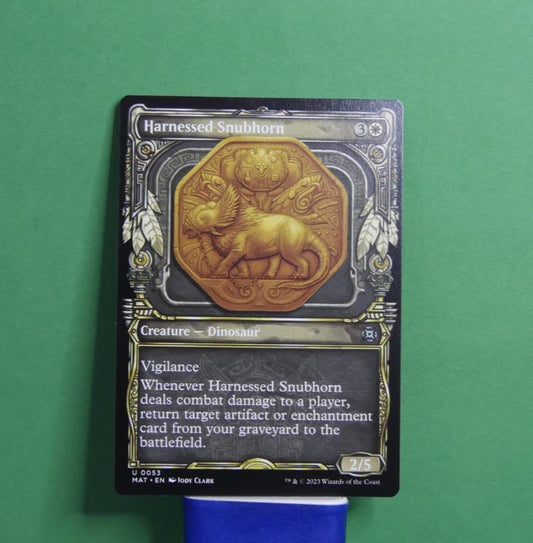 Harnessed Snubhorn Showcase MTG card from March of the Machine Aftermath MAT 53 by DM Vault Co
