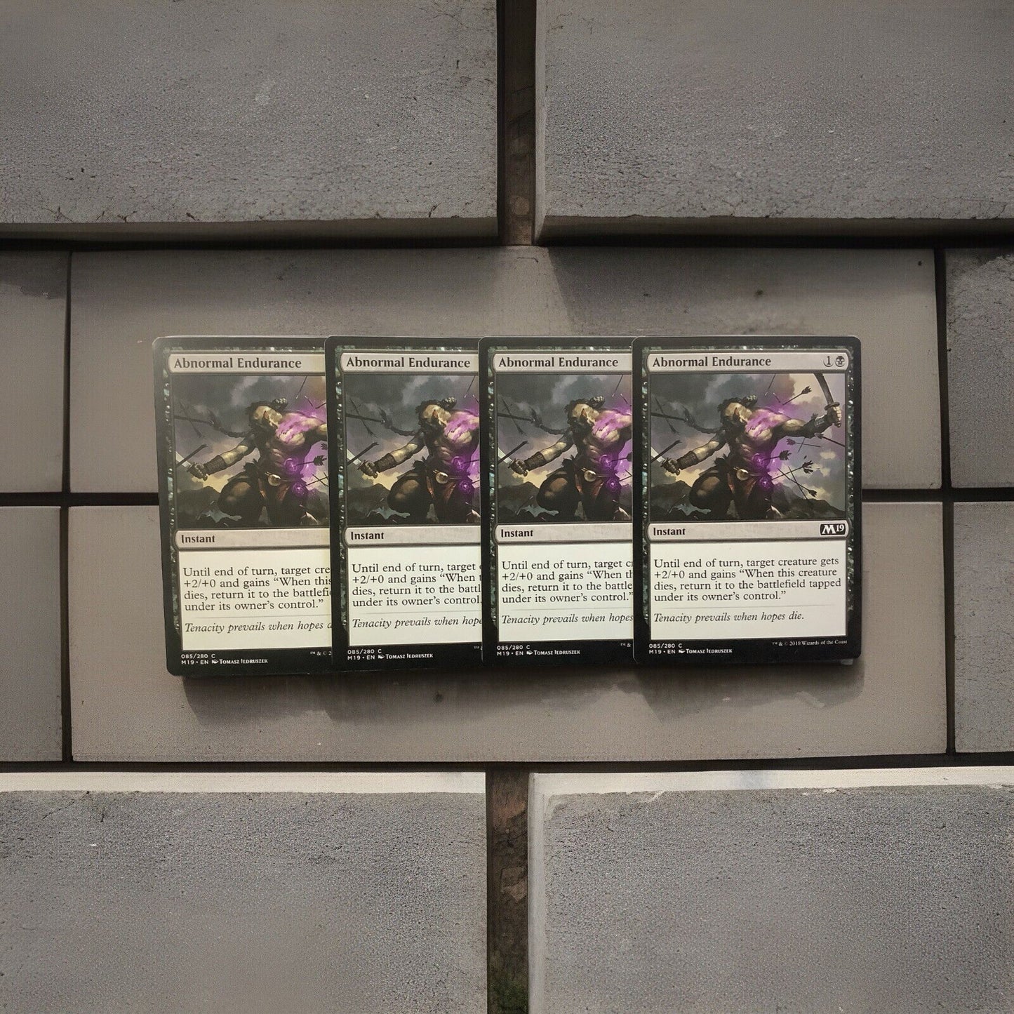 Abnormal Endurance M19 085 Magic the Gathering black instant combat trick card playset of four.