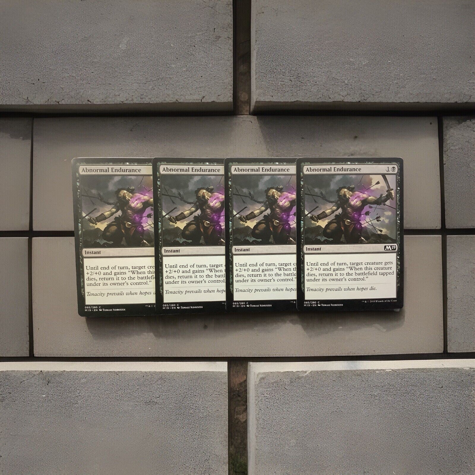 Abnormal Endurance M19 085 Magic the Gathering black instant combat trick card playset of four.