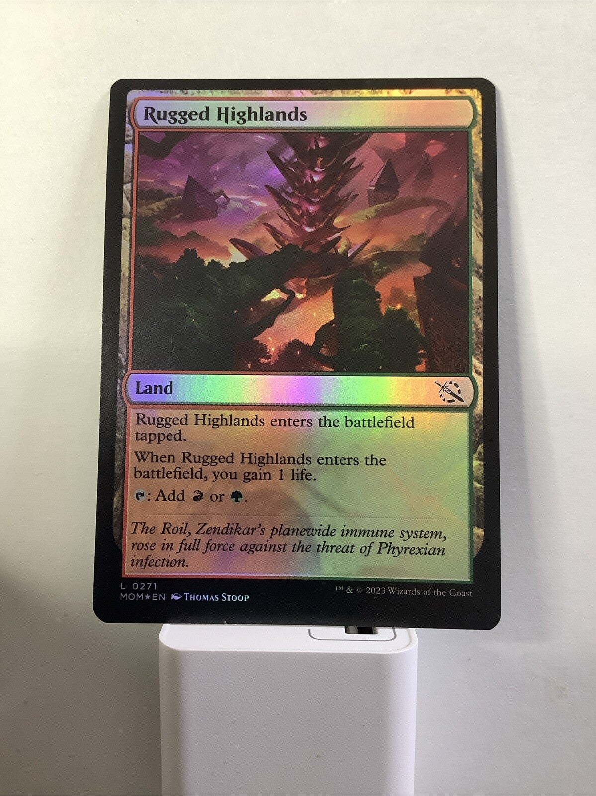 Rugged Highlands MOM 271 Foil from March of the Machine.
