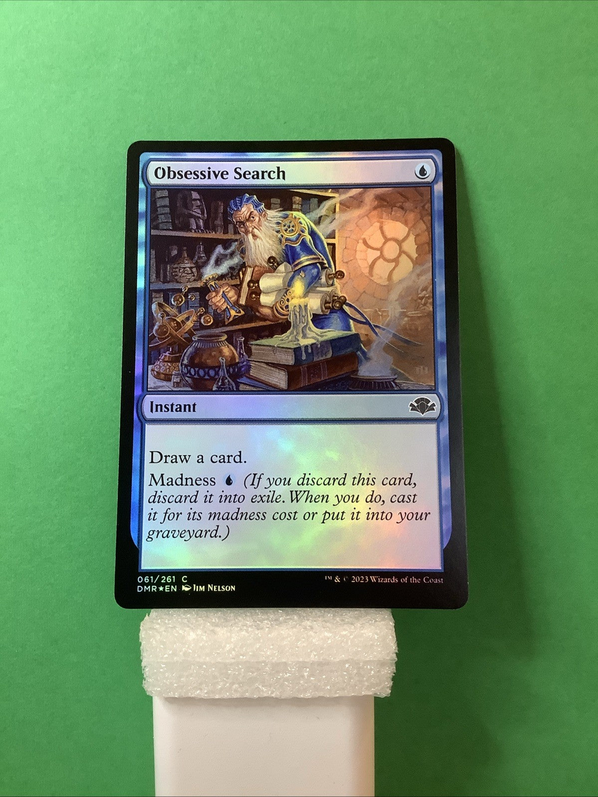 Magic: The Gathering Obsessive Search foil instant card from Dominaria Remastered featuring wizard research artwork