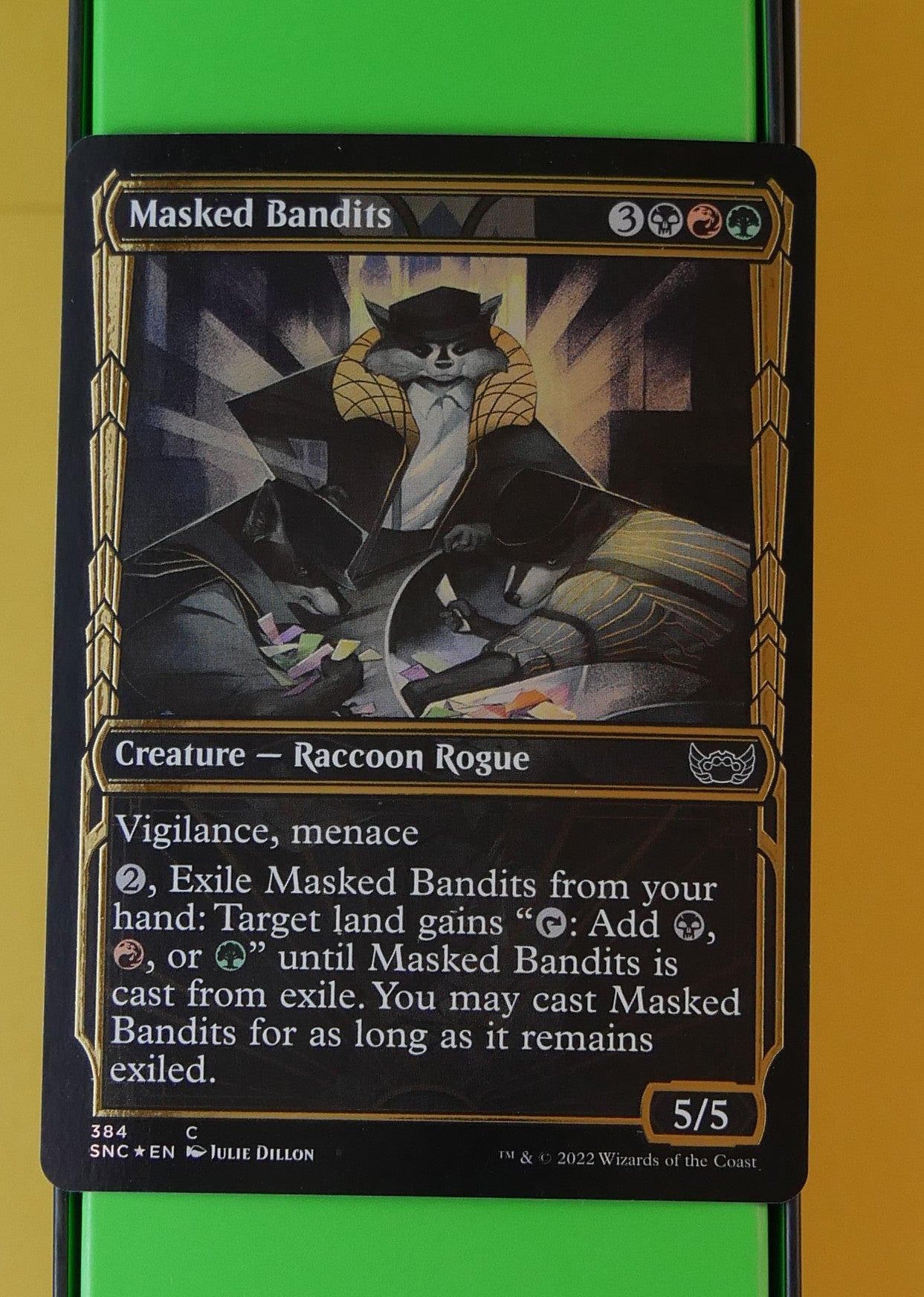 Masked Bandits SNC #384 Showcase Gilded Foil from Streets of New Capenna.